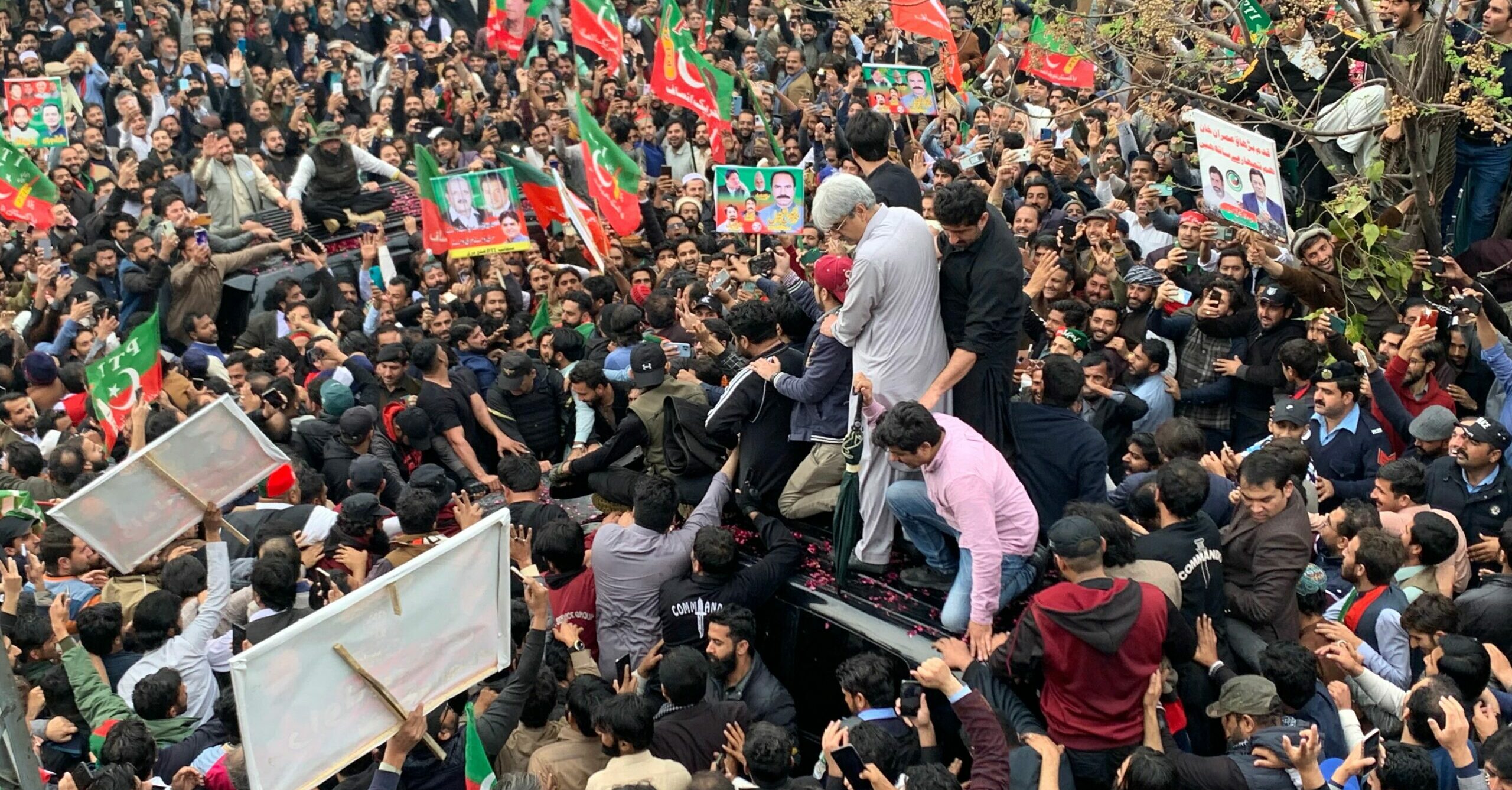 Image: Supporters gather around a car carrying Pakistan's former Prime Minister Imran Khan (not pictured) after he appeared at the court in Islamabad on February 28, 2023. Photo by Farooq Naeem/AFP via Getty Images.