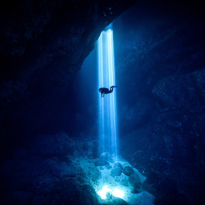Sunlight seeping through on scuba diver