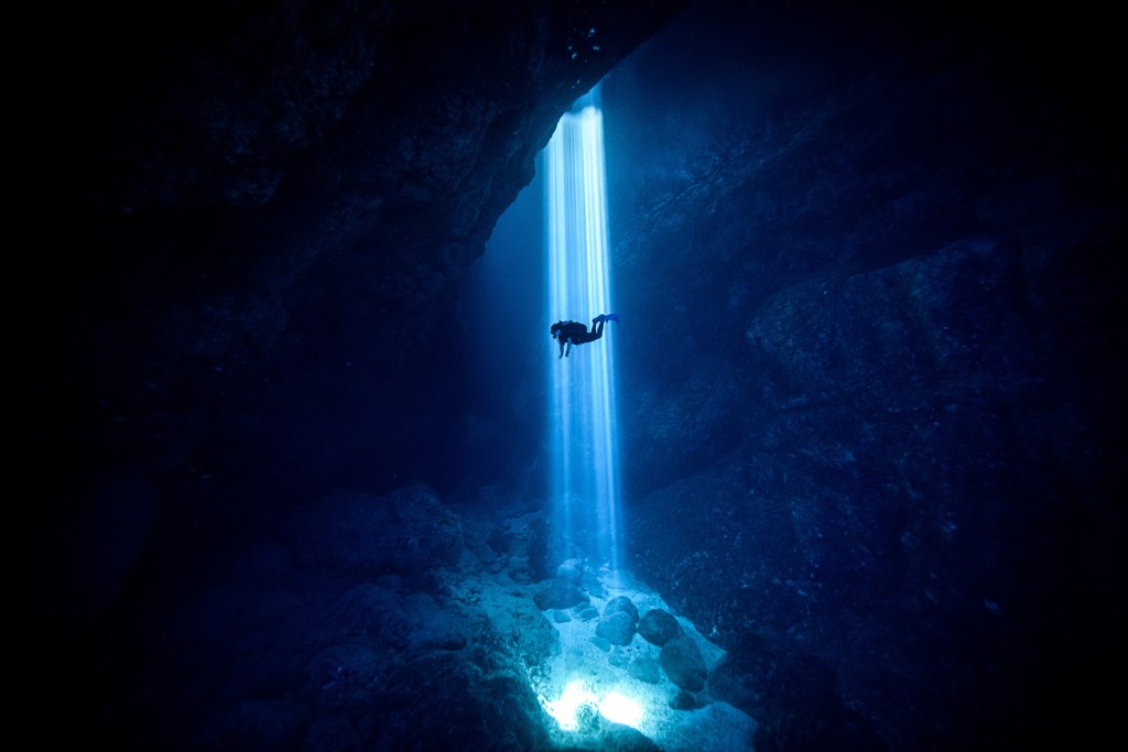 Sunlight seeping through on scuba diver